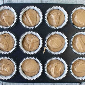 Light brown batter in cupcake papers.