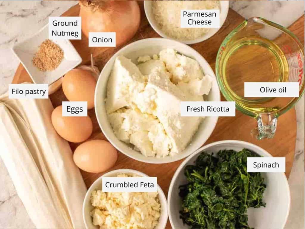 brown onion, grated parmesan cheese, olive oil, cooked spinach, crumbled feta, filo pastry, eggs, ground nutmeg and fresh ricotta