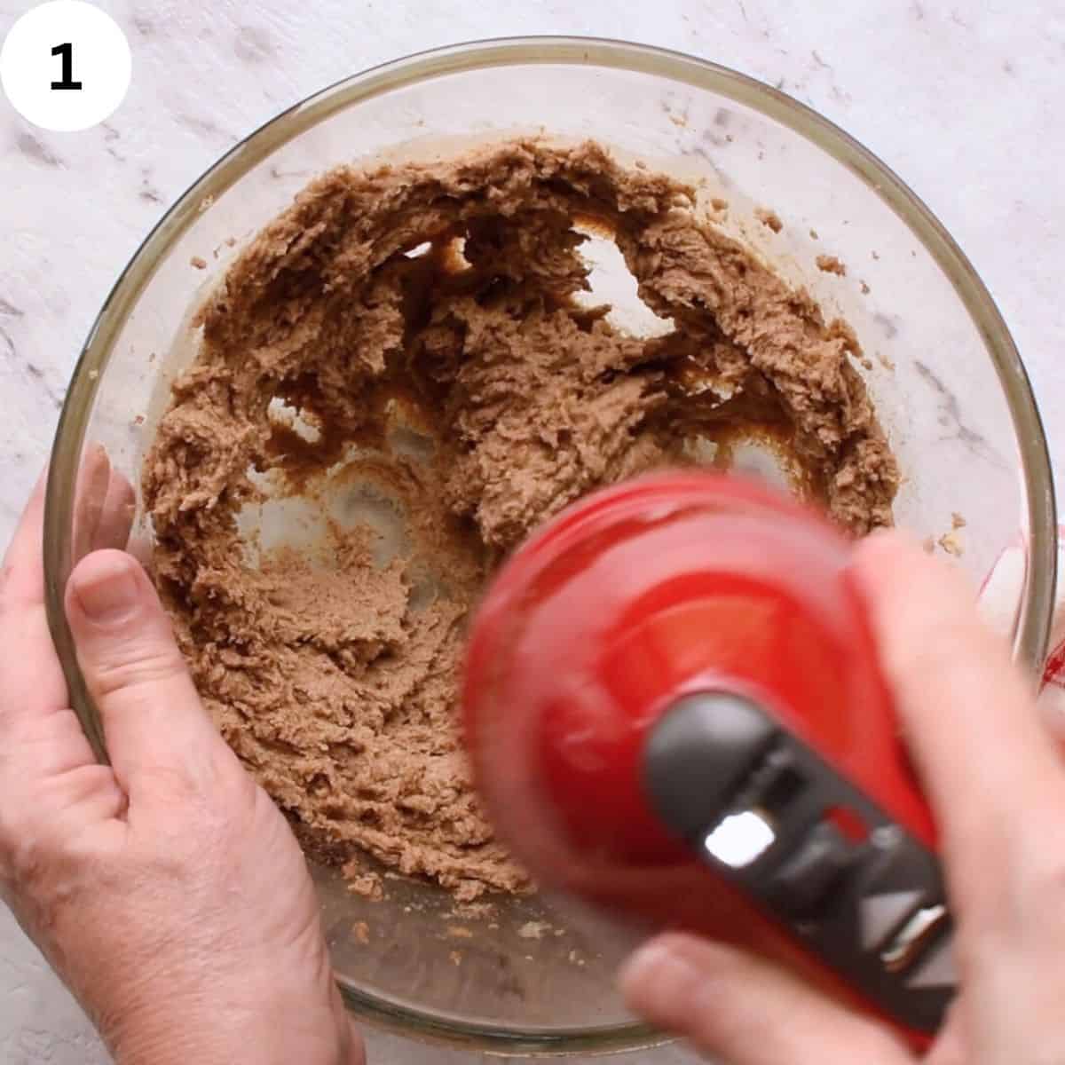 Creaming butter and brown sugar with handheld mixer.