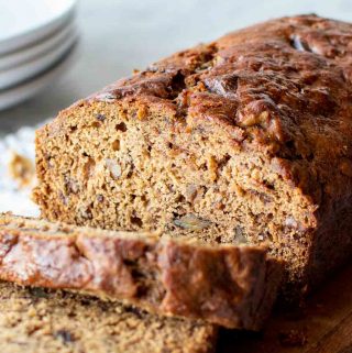 date bread on wooden board with slices cut