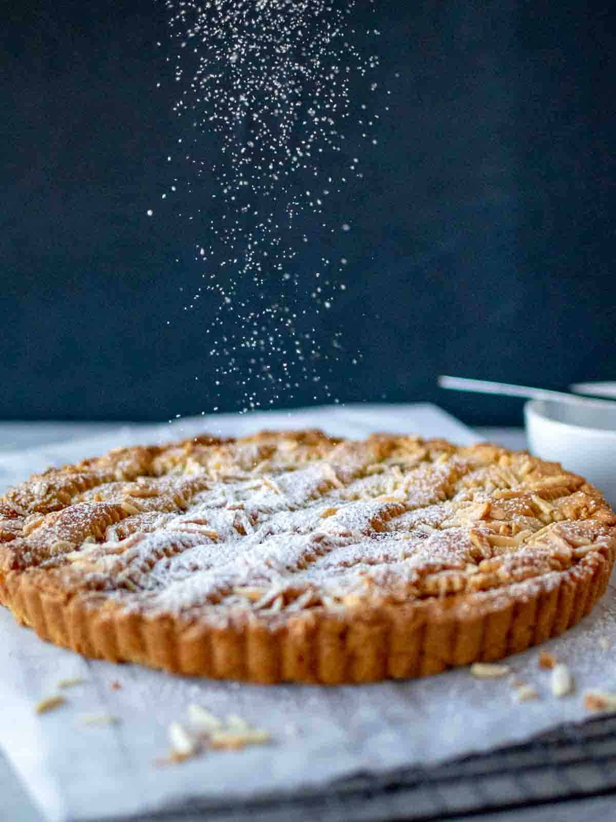 apricot pie being sprinkled with sugar.