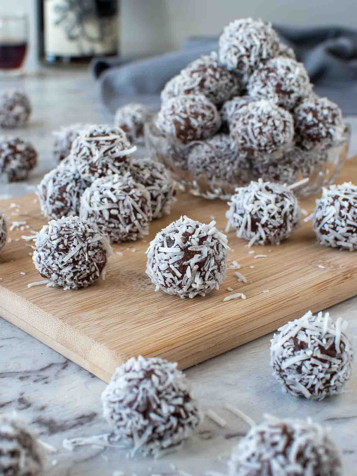 pile of rum balls on wooden board.