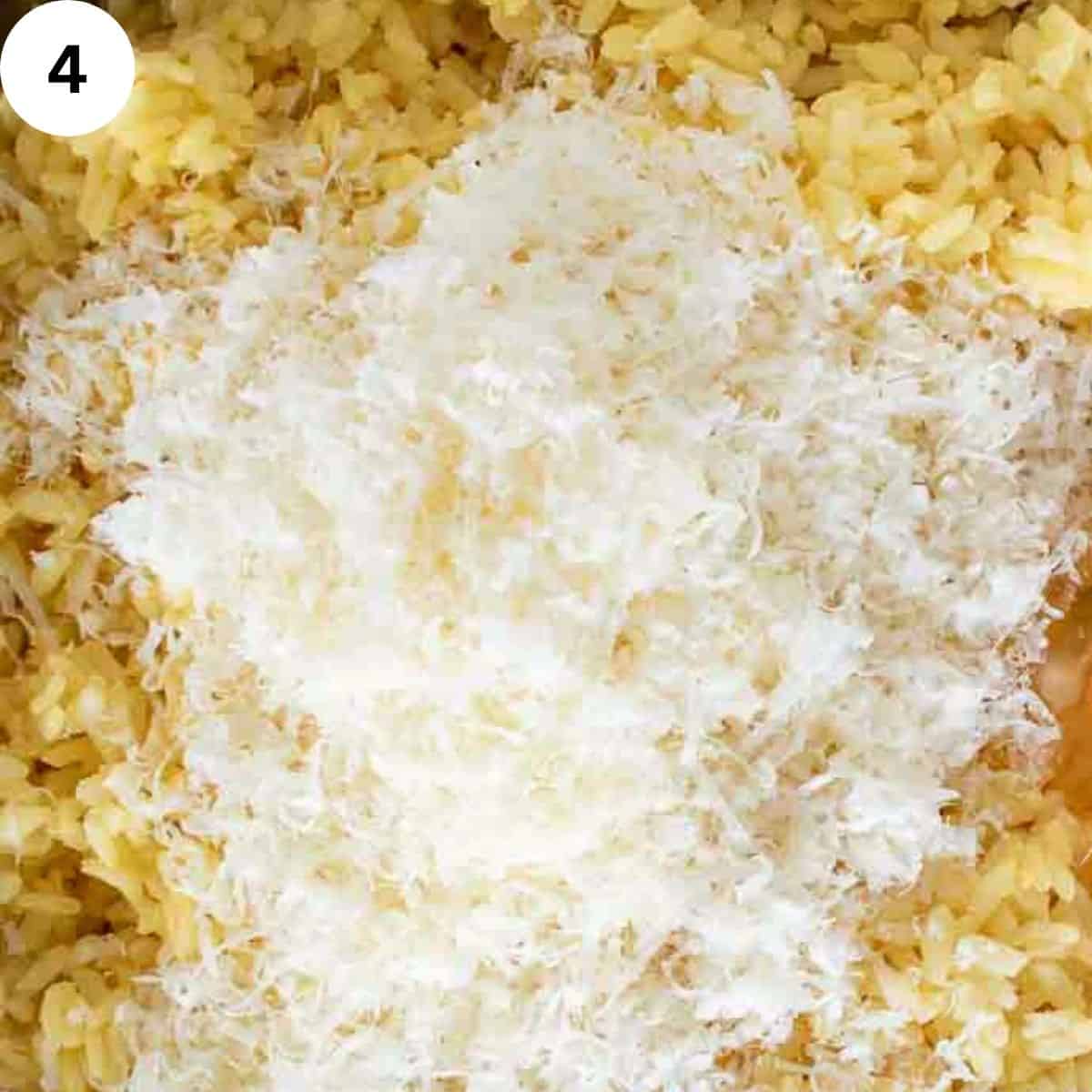 Finely grated Parmesan cheese piled on cooked yellow rice.