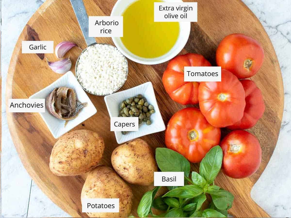 ingredients for stuffed baked tomatoes with rice as in the recipe card.