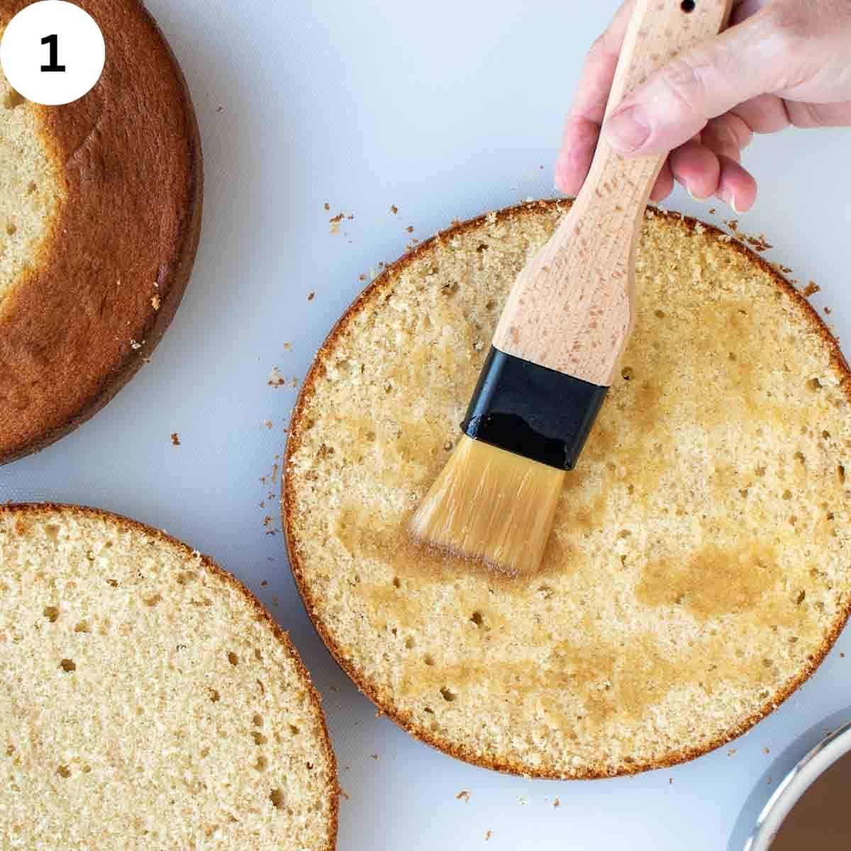 Brushing liquid onto cut surface of a cake.