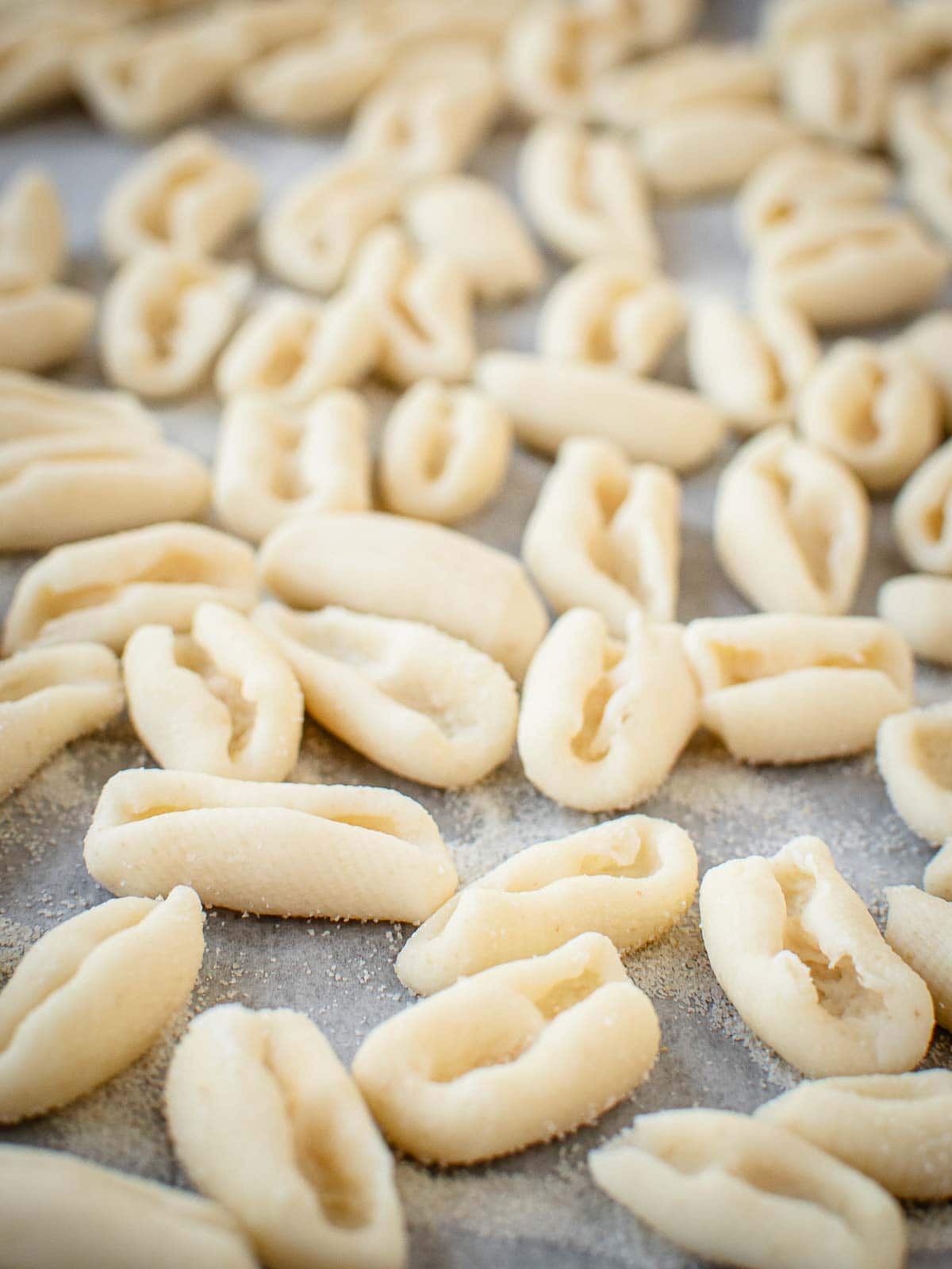 Close up of Homemade Cavatelli pasta on parchment paper.