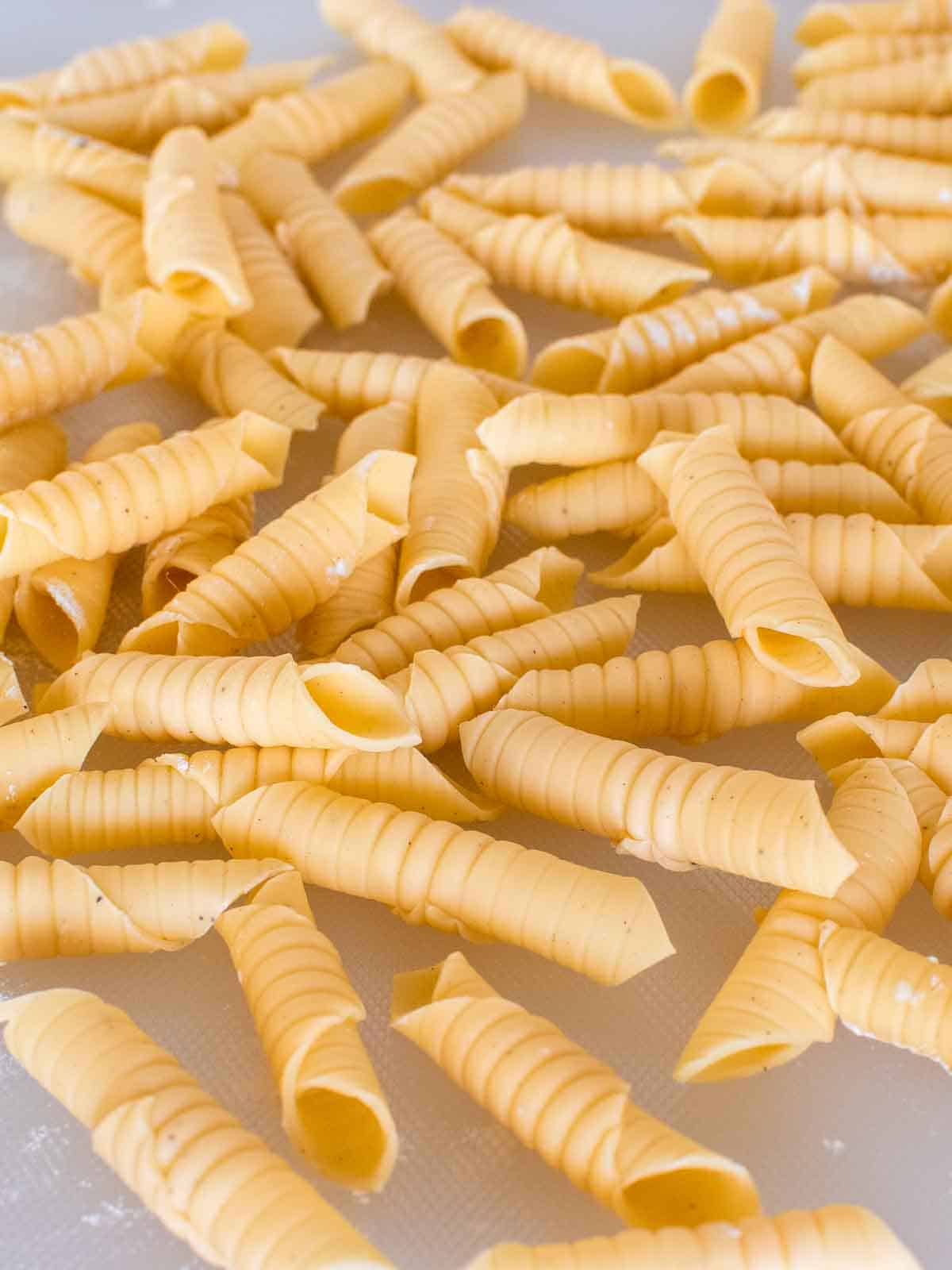 Homemade Garganelli pasta piled up before cooking.