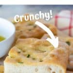 Image with text. Text reads Homemade ligurian focaccia. Image is slices of focaccia stacked with white bowl of oil on the side.