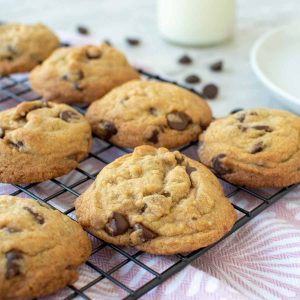 chocolate chip cookies on black wire rack.