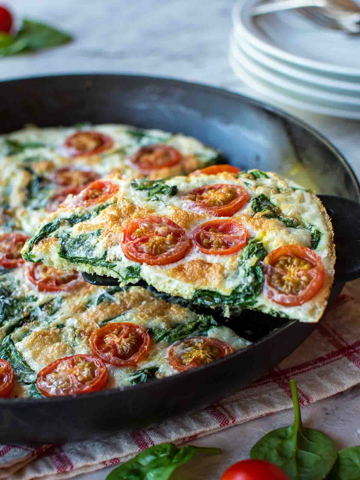 A slice of the egg white frittata being lifted out of the pan.
