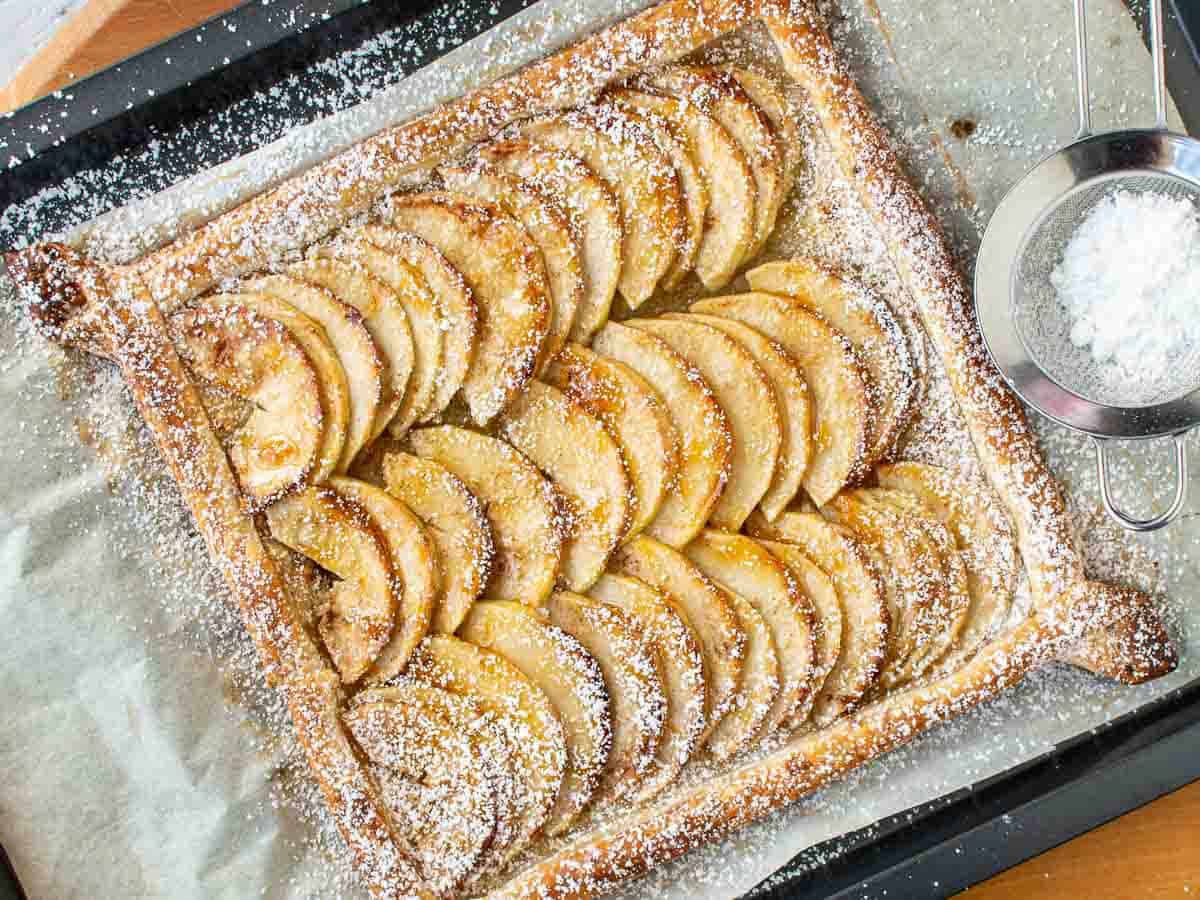 Baked puff pastry square topped with apple slices viewed from above.