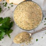 italian bread crumbs in glass jar with a spoonful of crumbs viewed from above