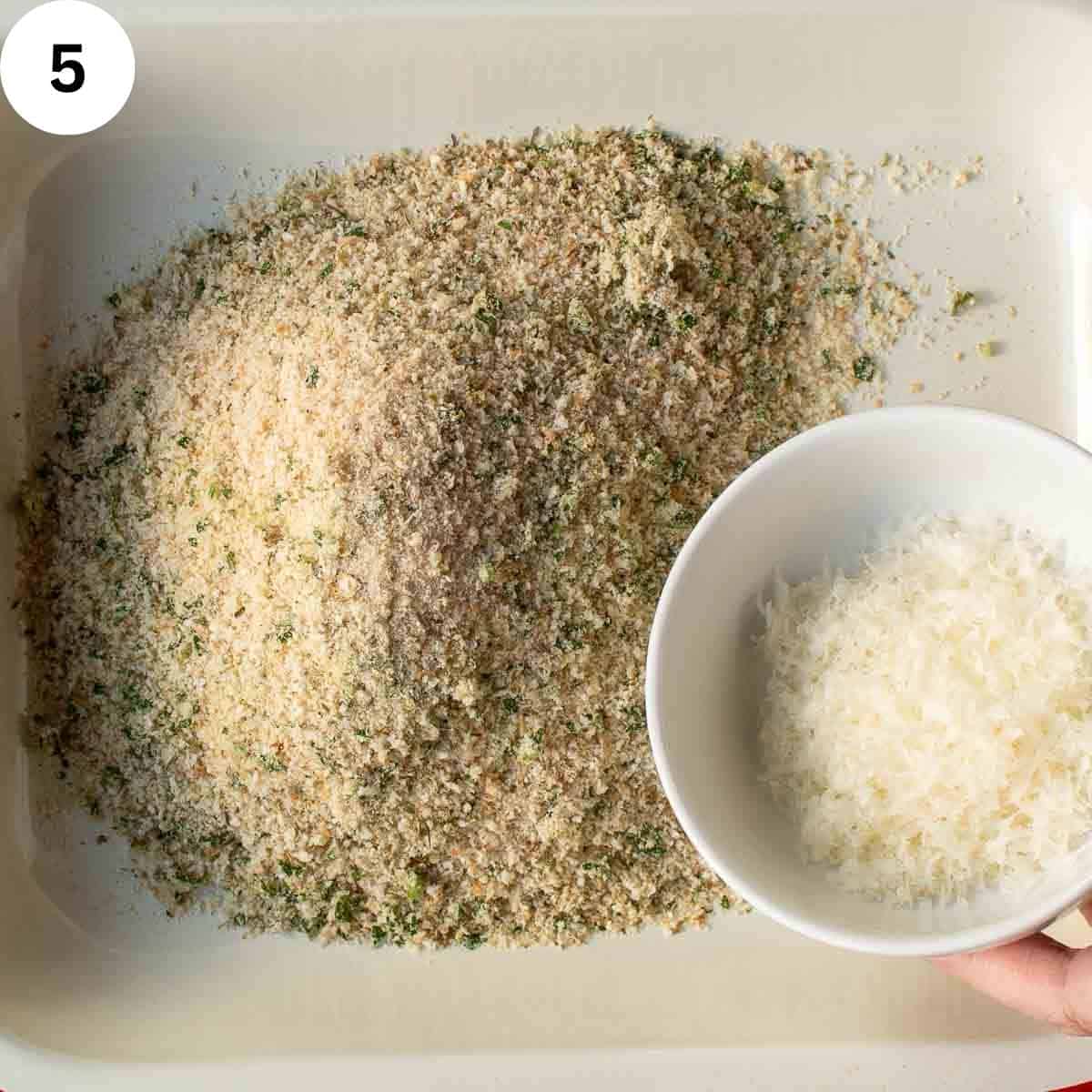 Adding finely grated cheese to breadcrumbs.