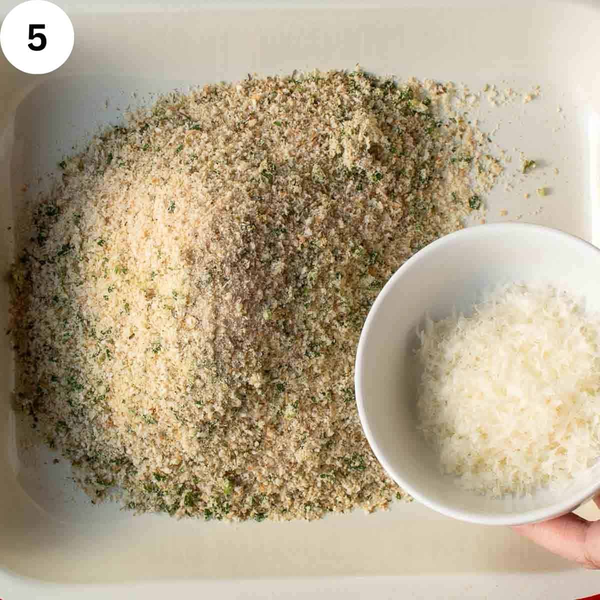 Adding finely grated cheese to breadcrumbs.