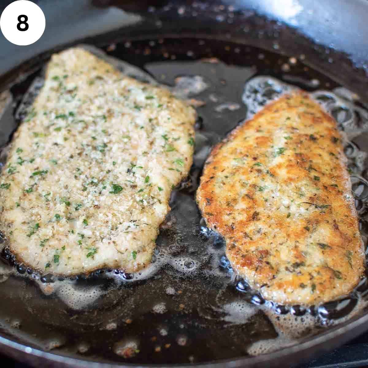 Breaded chicken breast frying in oil.