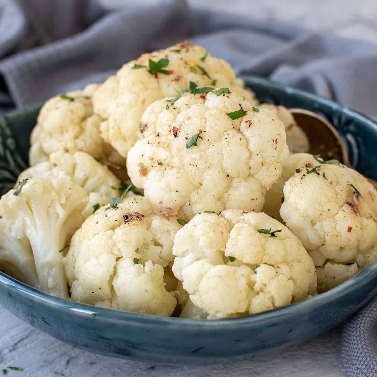 Finished Instant Pot Cauliflower in blue bowl on table.