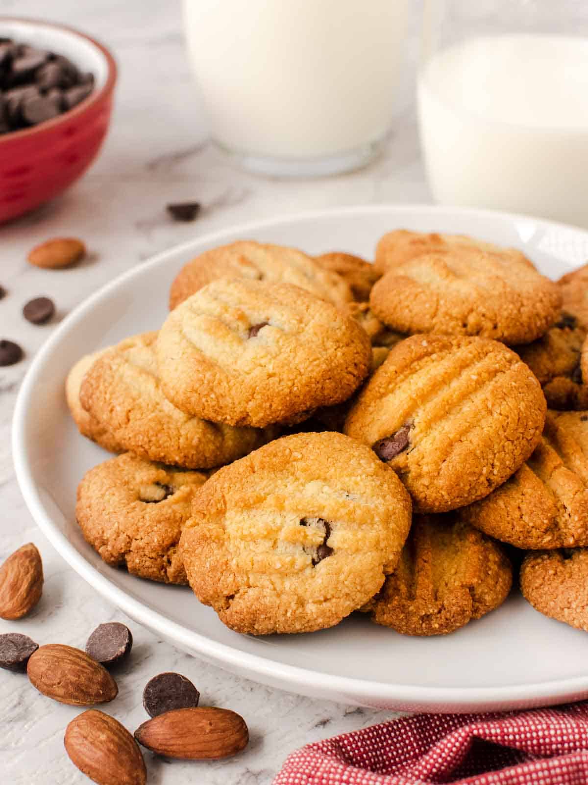 Almond flour cookies with chocolate chips on a white plate.