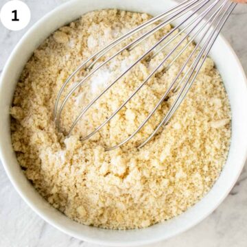Whisking almond flour and baking powder in a bowl.
