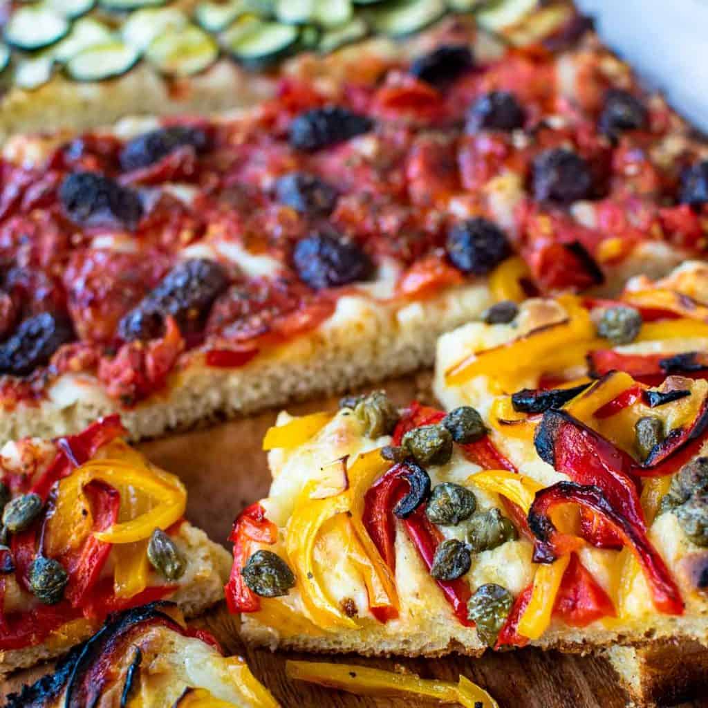 rectangle bread topped with three different toppings.