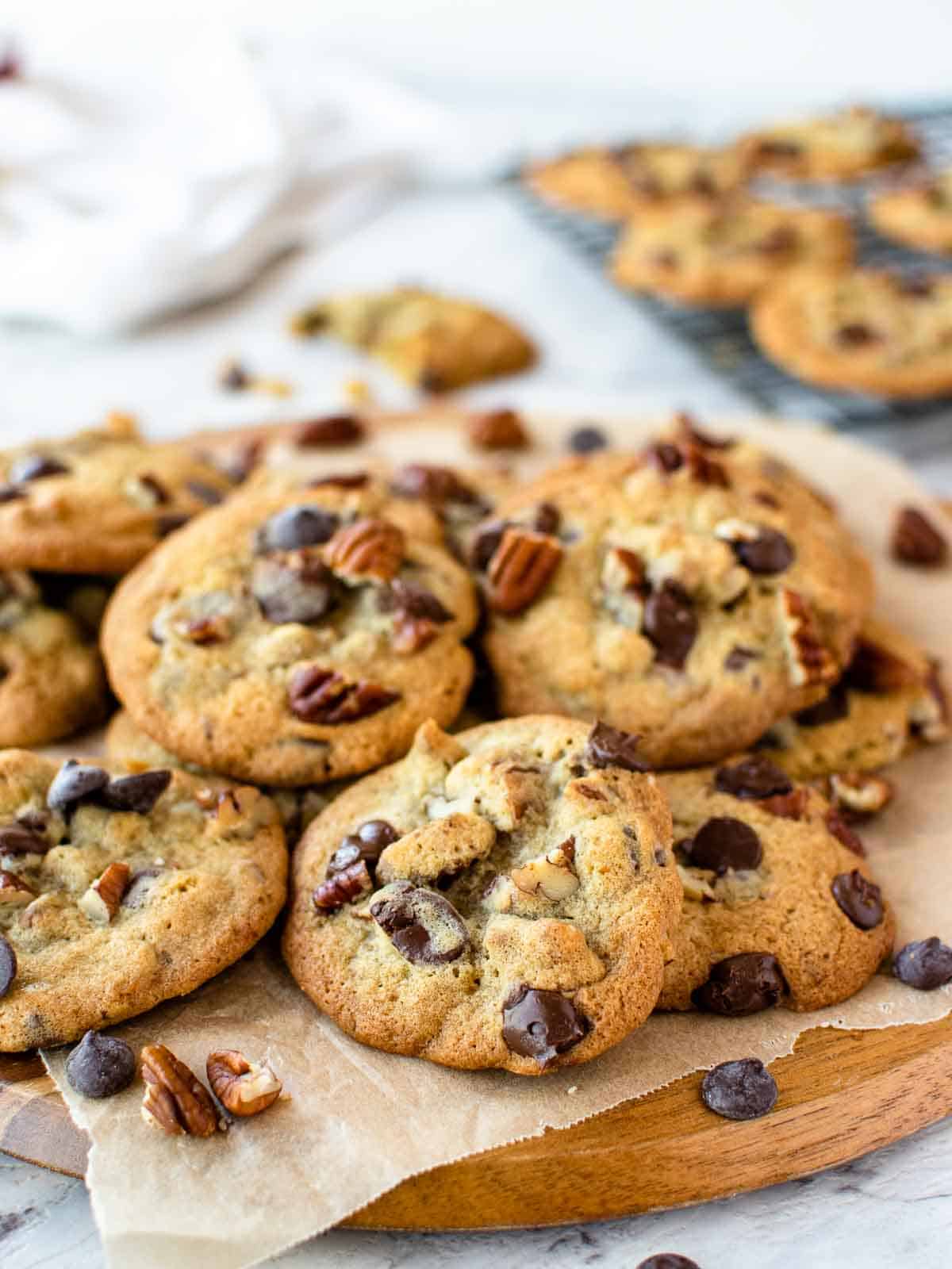 pile of cookies with choc chips and pecan on top.