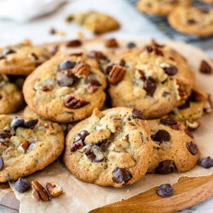 pile of cookies with choc chips and pecan on top.
