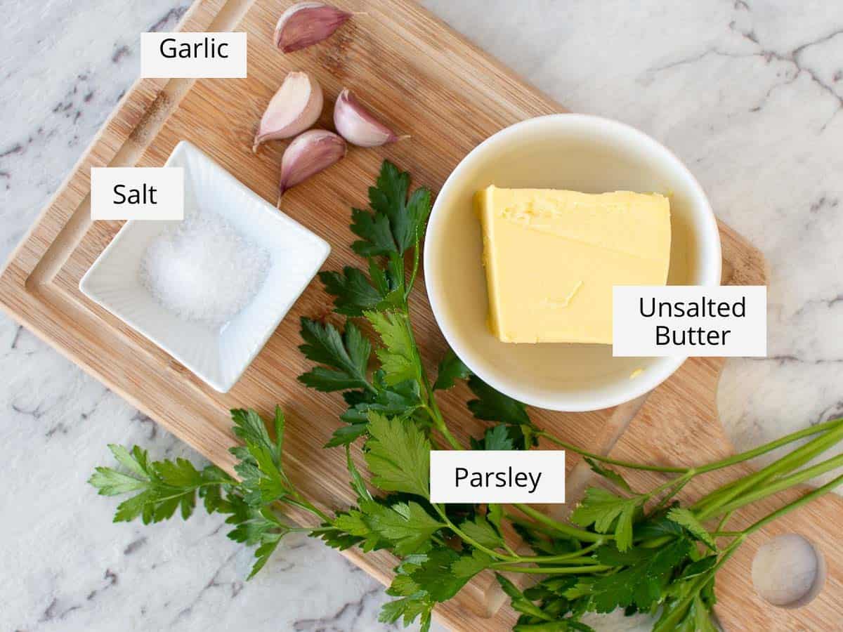 Ingredients required to make the recipe labelled and prepared on a wooden cutting board. 