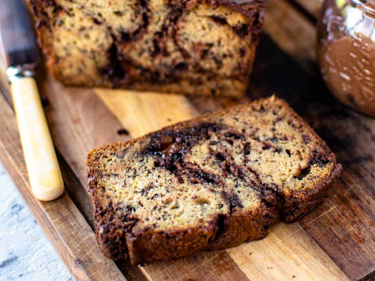 Close up of a slice of banana bread with chocolate swirls.