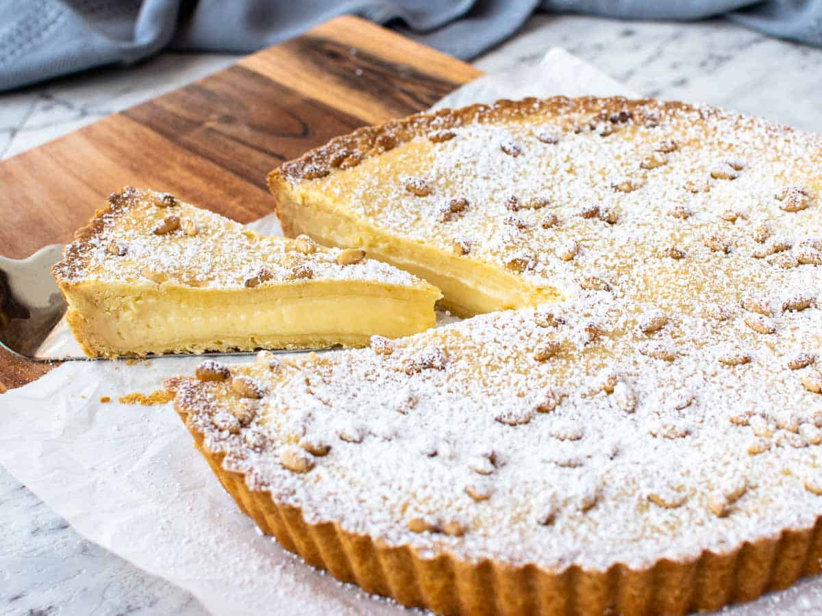 Pie with pastry cream filling with a slice cut and pulled out.