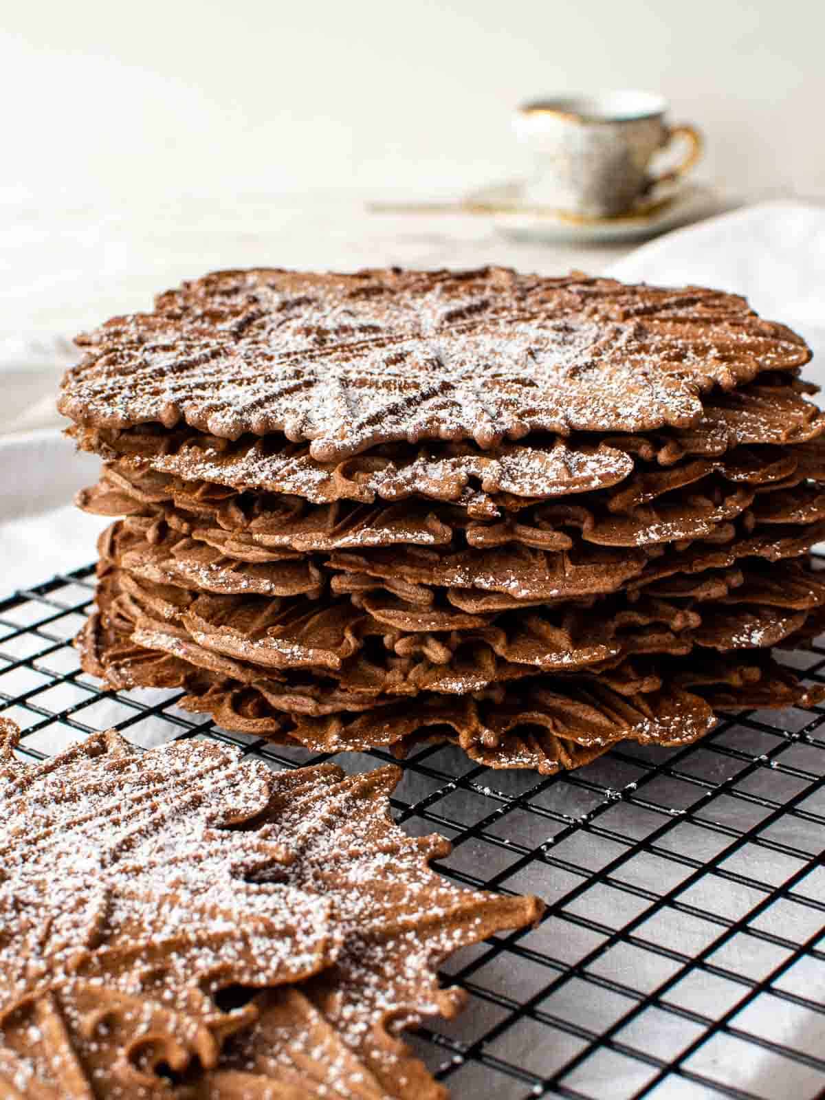 stack of chocolate wafer cookies on black wire rack.