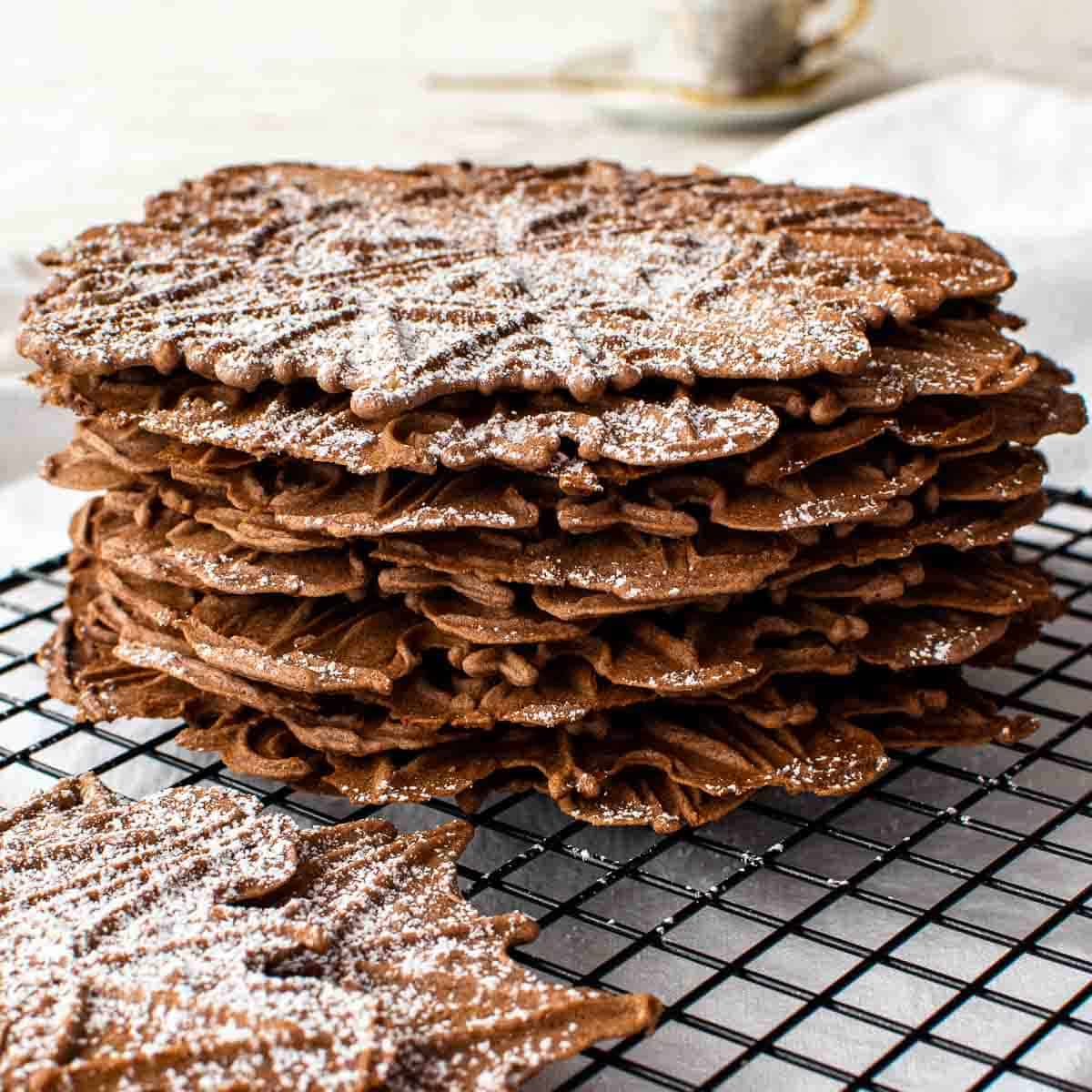 stack of chocolate wafer cookies on black wire rack.