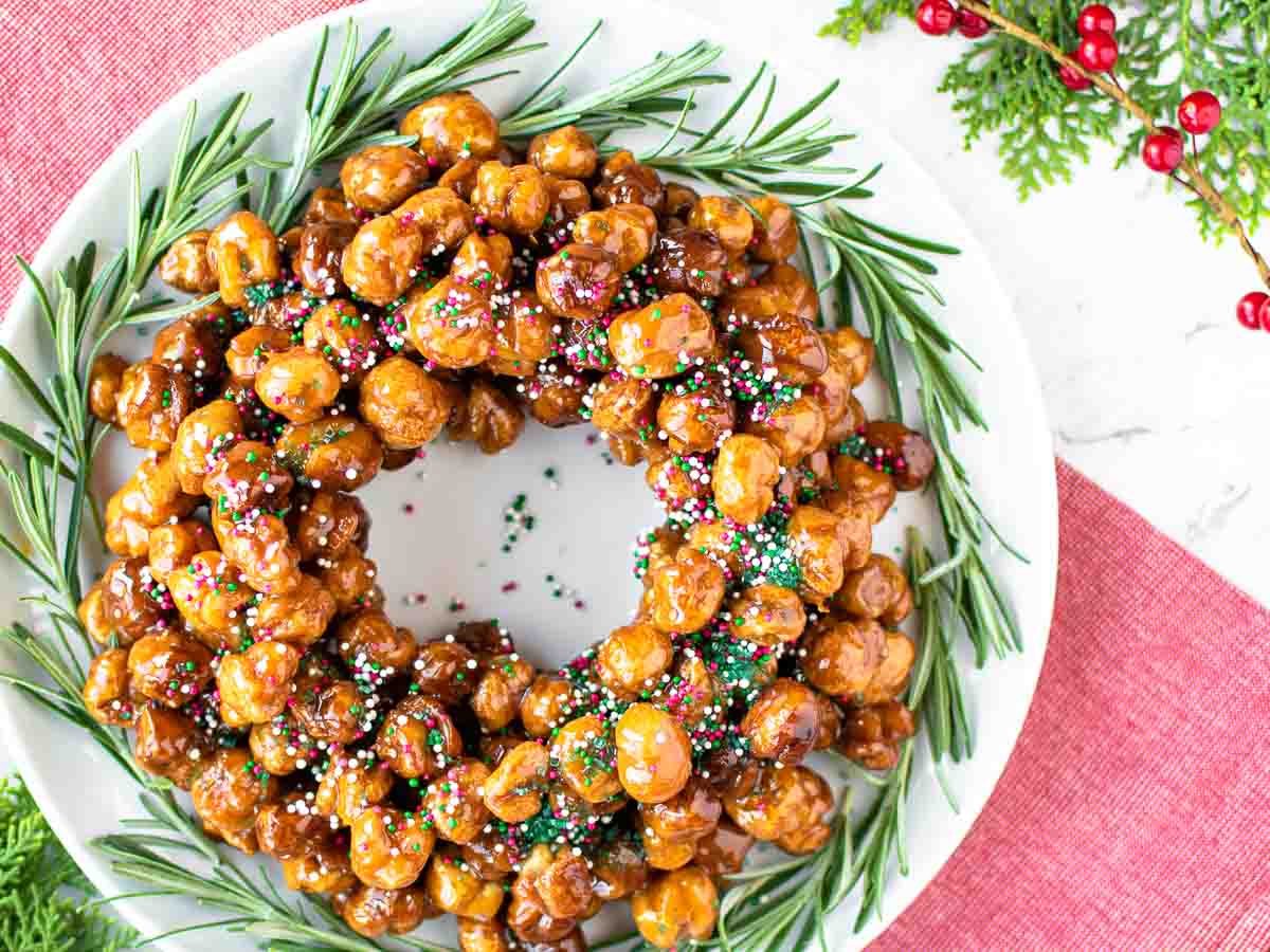 golden brown fried dough balls in the shape of a wreath viewed from above.