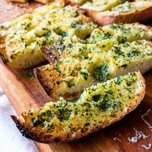 slice of toasted ciabatta bread topped with herbs.