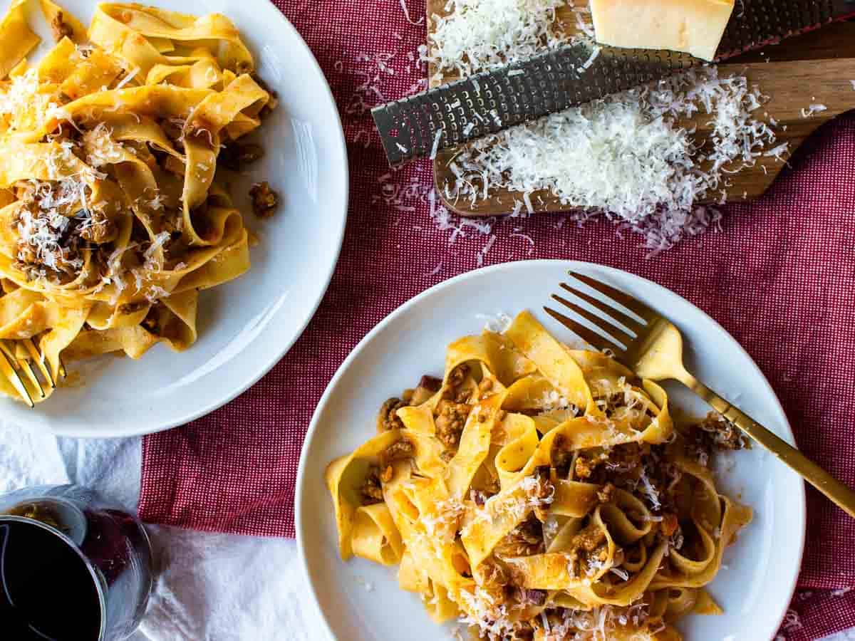 Overhead view of two plates of pasta.