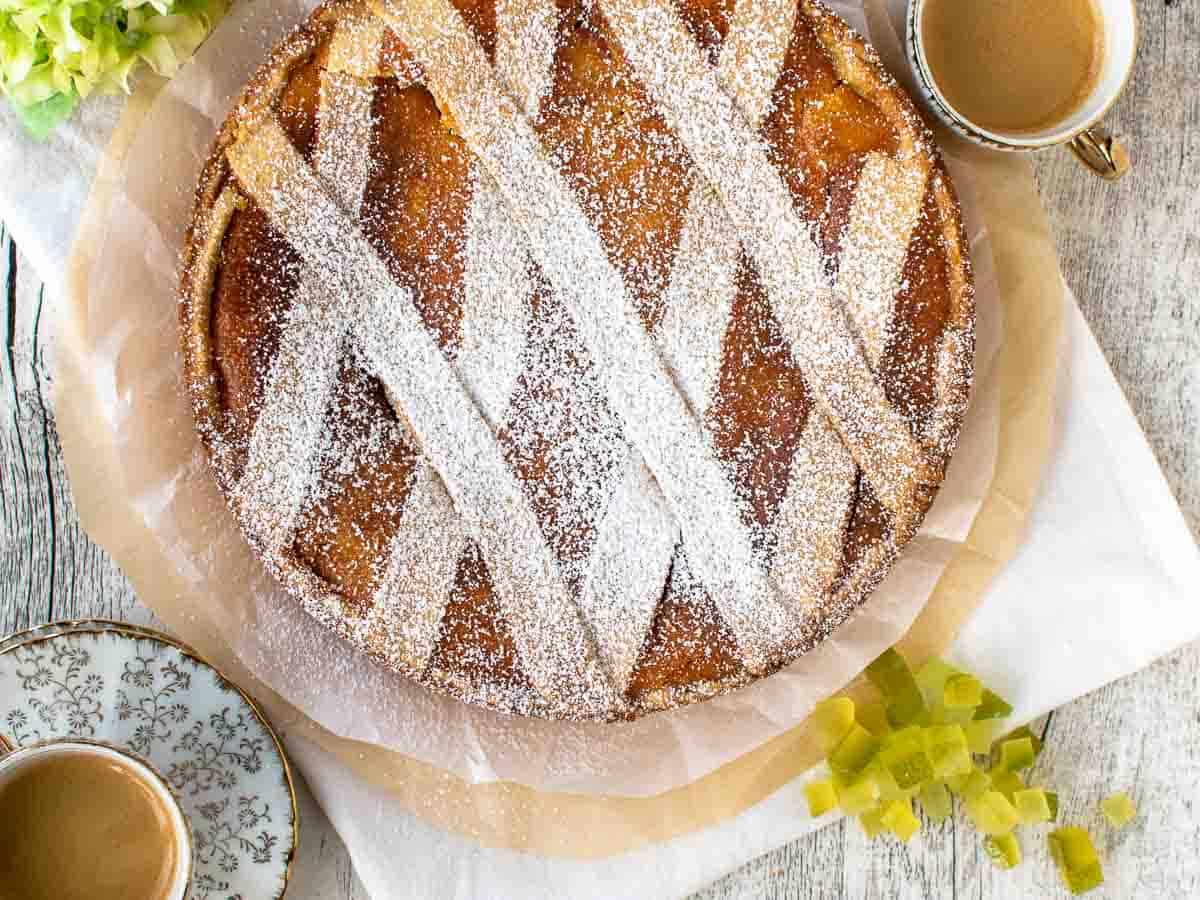 A round pie with lattice top dusted with powdered sugar viewed overhead.