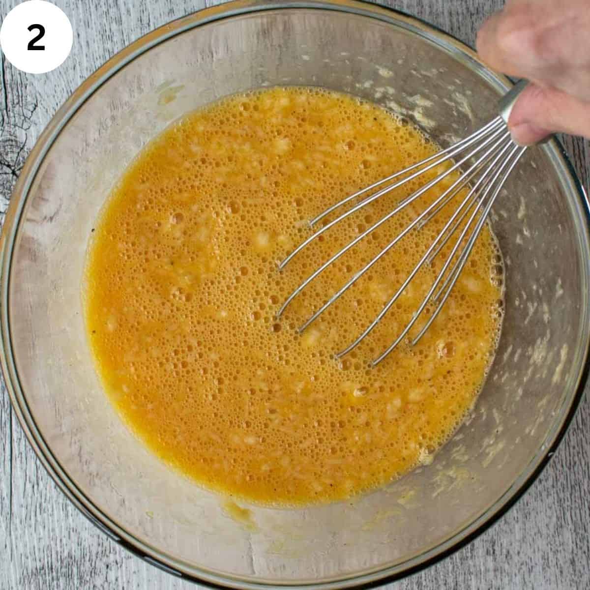 Whisking egg and cheese mixture.