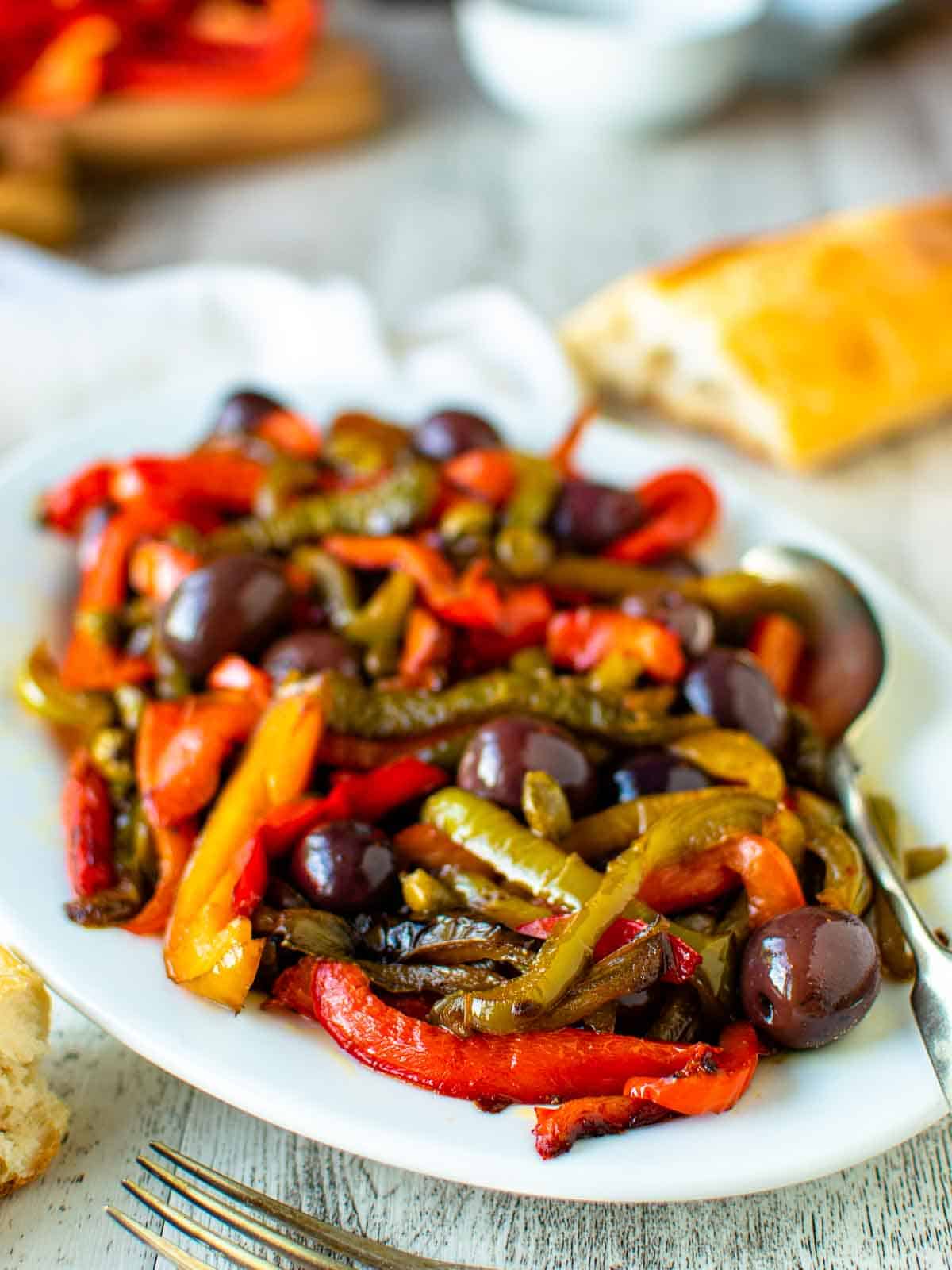 White plate of multi colored strips of fried bell peppers.