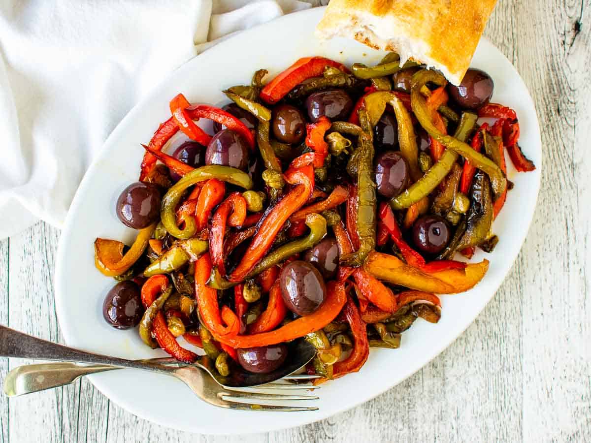 Overhead view of fried multi colored bell peppers on white plate.