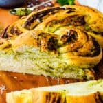 Sliced braided bread with pesto swirl.