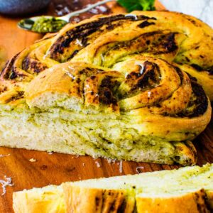 Sliced braided bread with pesto swirl.