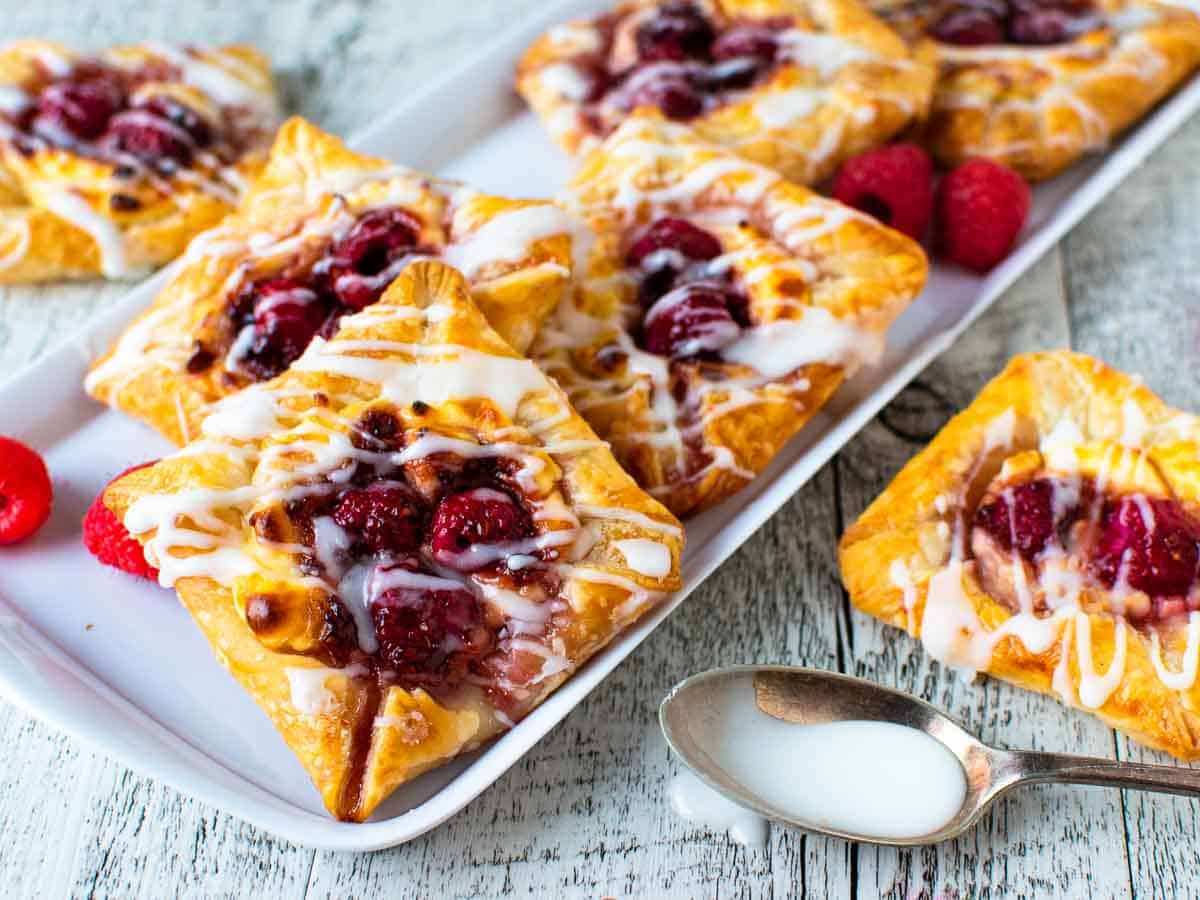 Close up of puff pastry danish with raspberry filling.