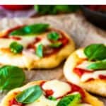 Three pizza fritta in a staggered row with tomato sauce, cheese and basil leaves.
