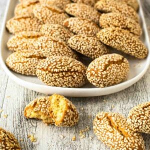 Italian Sesame Cookies arranged on a white plate.