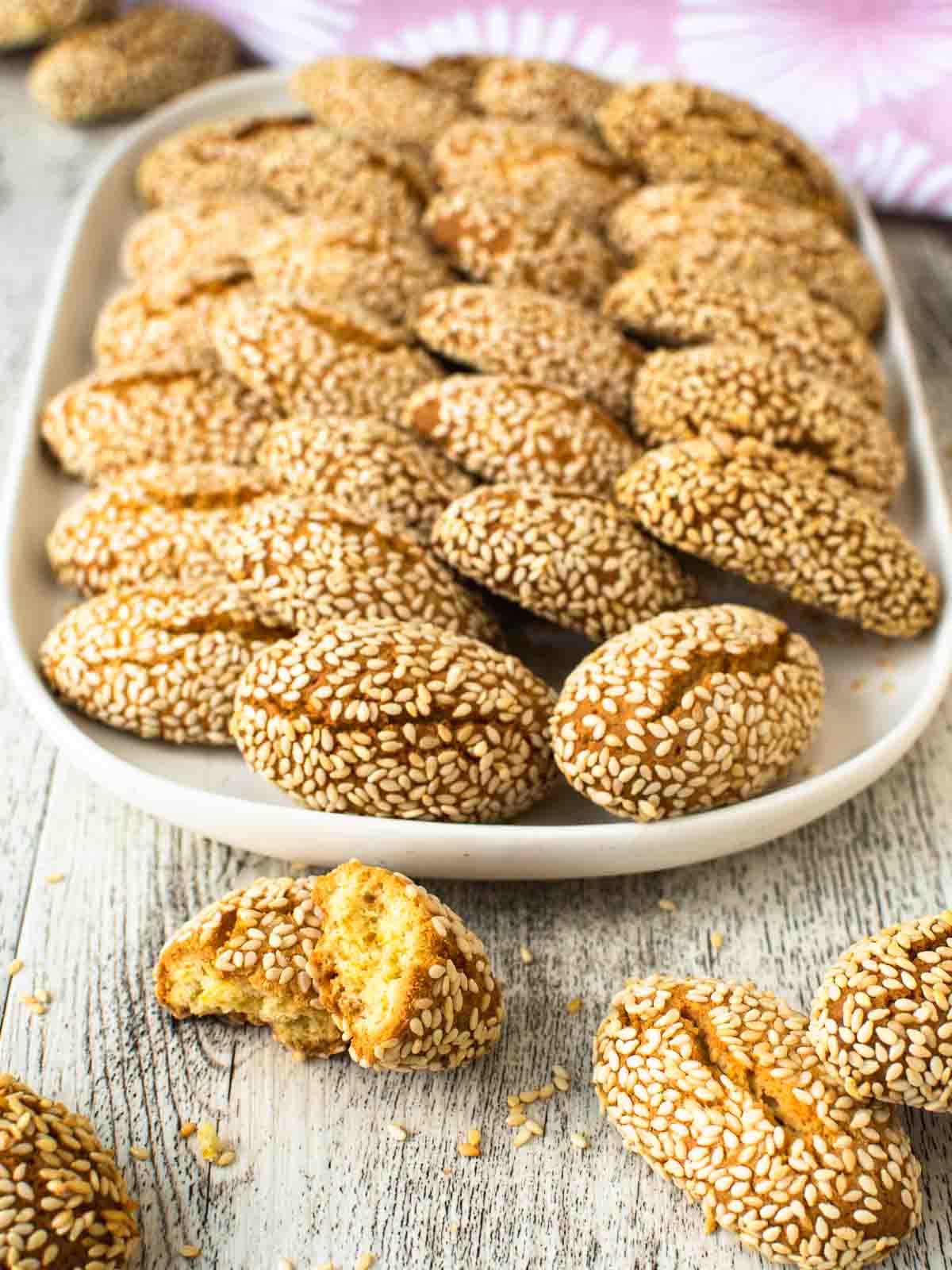 Italian Sesame Cookies arranged on a white plate.