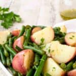 Green beans and potatoes on a white plate.