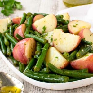 Green beans and potatoes on a white plate.