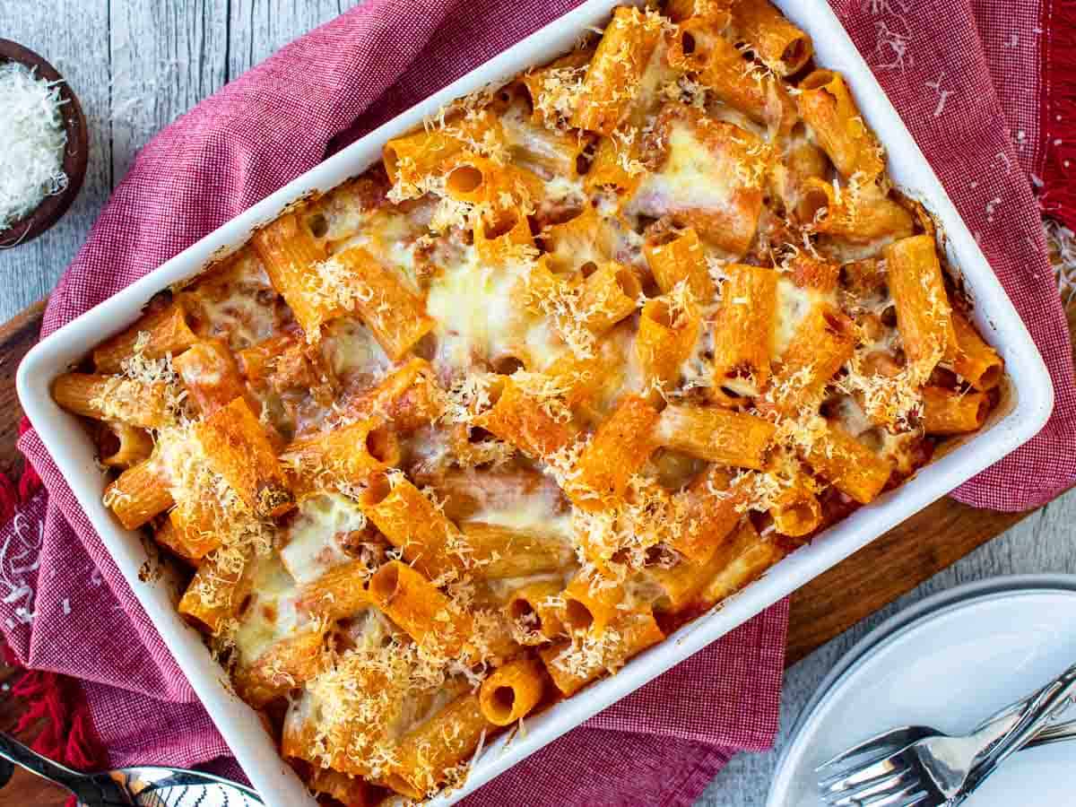 Overhead view of baked Italian pasta in a white baking dish.