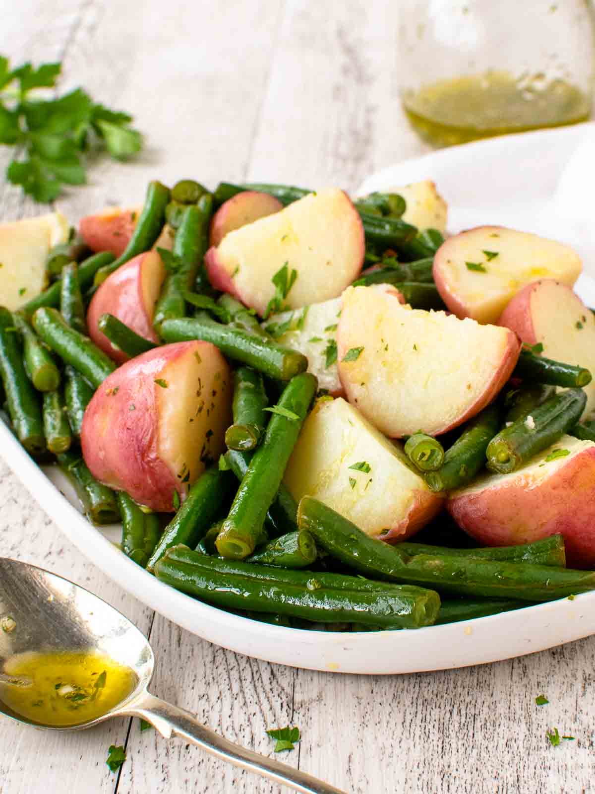 Green beans and pototoes on a white plate.