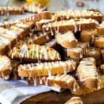 A pile of Lemon Biscotti drizzled with lemon icing.