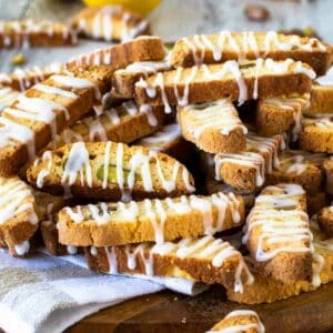 A pile of Lemon Biscotti drizzled with lemon icing.