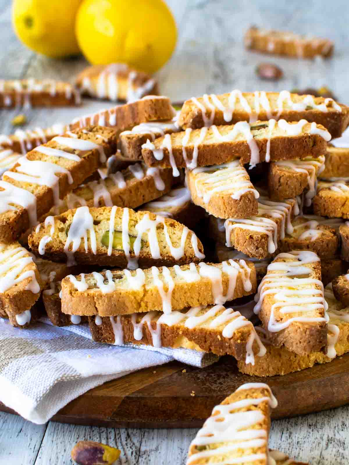 A pile of Lemon Biscotti drizzled with lemon icing.